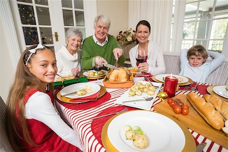 simsearch:400-07929054,k - Grandfather carving roats turkey during christmas dinner at home in the living room Stock Photo - Budget Royalty-Free & Subscription, Code: 400-07928994