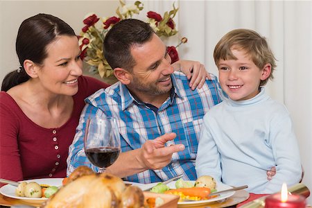 simsearch:400-07928326,k - Portrait of parents and son at christmas dinner at home in the living room Photographie de stock - Aubaine LD & Abonnement, Code: 400-07929017