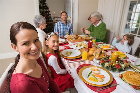 simsearch:400-07929054,k - Festive mother and daughter smiling at camera at home in the living room Stock Photo - Budget Royalty-Free & Subscription, Code: 400-07929040