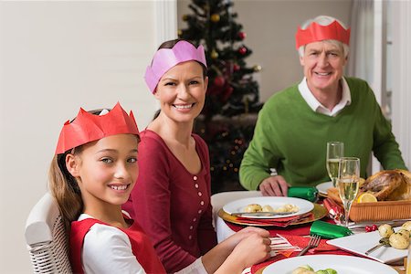 simsearch:400-07929054,k - Smiling extended family in party hat at dinner table at home in the living room Stock Photo - Budget Royalty-Free & Subscription, Code: 400-07929054