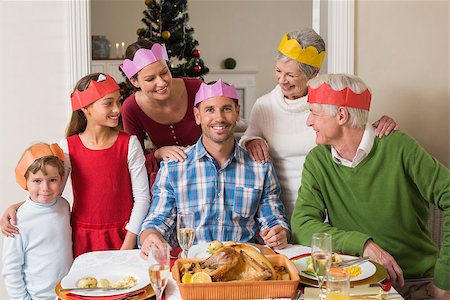 simsearch:400-07929054,k - Cheerful extended family in party hat at dinner table at home in the living room Stock Photo - Budget Royalty-Free & Subscription, Code: 400-07929061