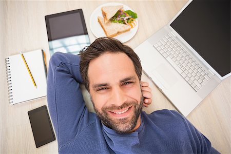 simsearch:400-07931092,k - Happy man lying on floor surrounded by his things at home in the living room Foto de stock - Super Valor sin royalties y Suscripción, Código: 400-07929290