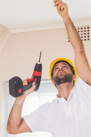 simsearch:400-07929714,k - Construction worker drilling hole in ceiling in a new house Stock Photo - Budget Royalty-Free & Subscription, Code: 400-07929325