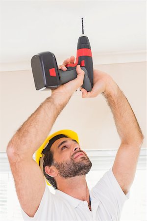 simsearch:400-07929840,k - Construction worker drilling hole in ceiling in a new house Foto de stock - Super Valor sin royalties y Suscripción, Código: 400-07929326