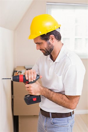 simsearch:400-07929714,k - Construction worker drilling hole in wall in a new house Stock Photo - Budget Royalty-Free & Subscription, Code: 400-07929327