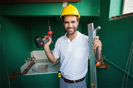 simsearch:400-07929714,k - Construction worker holding spirit level and drill in a new house Stock Photo - Budget Royalty-Free & Subscription, Code: 400-07929328