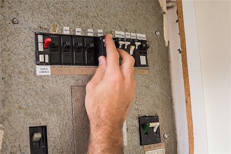 simsearch:400-07572493,k - Electrician working on the fuse box in the kitchen Stock Photo - Budget Royalty-Free & Subscription, Code: 400-07929455