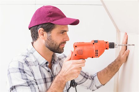 simsearch:400-07929714,k - Construction worker drilling hole in wall in a new house Stock Photo - Budget Royalty-Free & Subscription, Code: 400-07929518