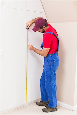 simsearch:400-07929714,k - Construction worker using measuring tape in a new house Stock Photo - Budget Royalty-Free & Subscription, Code: 400-07929525