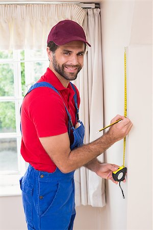 simsearch:400-07929714,k - Construction worker using measuring tape in a new house Stock Photo - Budget Royalty-Free & Subscription, Code: 400-07929528