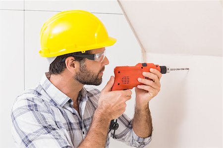 drilling wall - Construction worker drilling hole in wall in a new house Stock Photo - Budget Royalty-Free & Subscription, Code: 400-07929520