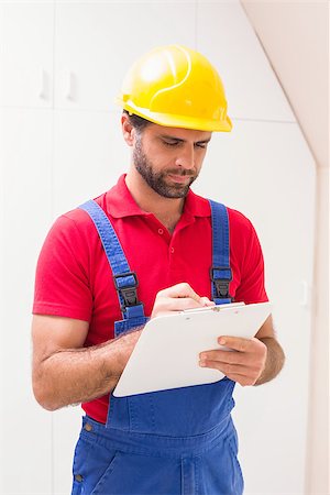 simsearch:400-07929714,k - Construction worker taking notes on clipboard in a new house Stock Photo - Budget Royalty-Free & Subscription, Code: 400-07929538