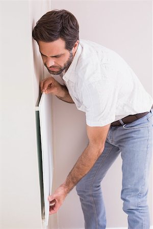 simsearch:400-07929840,k - Handyman hanging up a radiator in a new house Photographie de stock - Aubaine LD & Abonnement, Code: 400-07929549