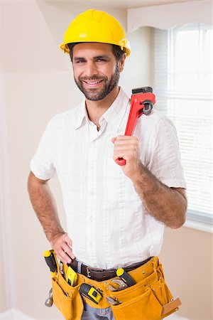 simsearch:400-07929840,k - Handyman smiling at camera in tool belt in a new house Photographie de stock - Aubaine LD & Abonnement, Code: 400-07929558