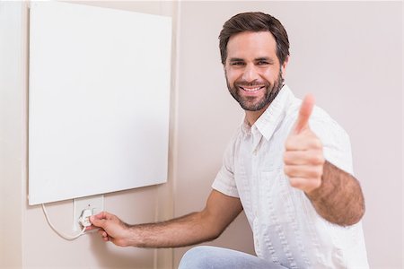 simsearch:400-07929840,k - Handyman hanging up a radiator in a new house Photographie de stock - Aubaine LD & Abonnement, Code: 400-07929552