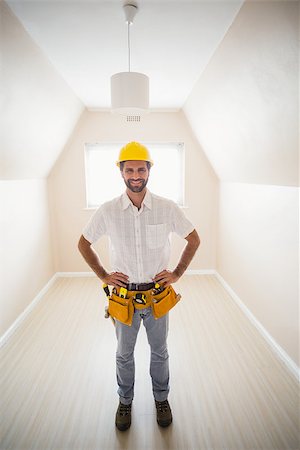 simsearch:400-07929840,k - Handyman smiling at camera in tool belt in a new house Photographie de stock - Aubaine LD & Abonnement, Code: 400-07929560