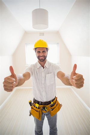 simsearch:400-07929840,k - Handyman smiling at camera in tool belt in a new house Photographie de stock - Aubaine LD & Abonnement, Code: 400-07929561