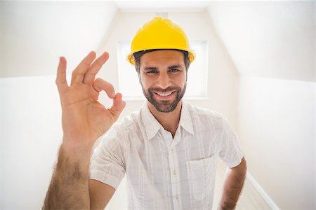 simsearch:400-07929840,k - Handyman smiling at camera in tool belt in a new house Photographie de stock - Aubaine LD & Abonnement, Code: 400-07929562