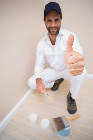 Painter showing thumbs up to camera in a new house Stock Photo - Budget Royalty-Free & Subscription, Code: 400-07929576