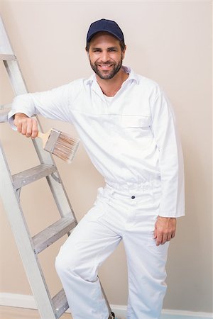 Painter smiling at the camera in a new house Stock Photo - Budget Royalty-Free & Subscription, Code: 400-07929570