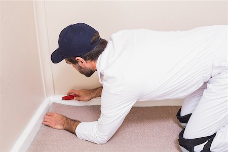 Handyman laying down a carpet in a new house Stock Photo - Budget Royalty-Free & Subscription, Code: 400-07929588