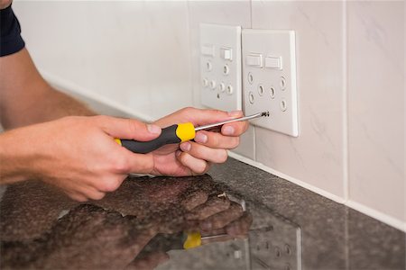 plug in with hand - Electrician unscrewing face plate of plug socket in the kitchen Stock Photo - Budget Royalty-Free & Subscription, Code: 400-07929694