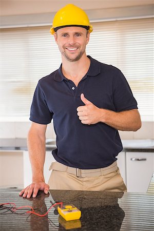 simsearch:400-07929714,k - Smiling construction worker giving thumbs up in the kitchen Stock Photo - Budget Royalty-Free & Subscription, Code: 400-07929705