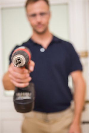 simsearch:400-07929714,k - Handyman pointing power tool at camera in a house Stock Photo - Budget Royalty-Free & Subscription, Code: 400-07929715