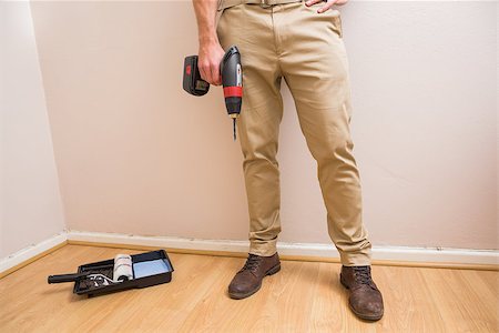 simsearch:400-07929840,k - Construction worker holding power tool in a new house Foto de stock - Super Valor sin royalties y Suscripción, Código: 400-07929717