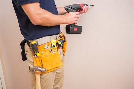 drilling wall - Construction worker drilling hole in wall in a new house Stock Photo - Budget Royalty-Free & Subscription, Code: 400-07929710