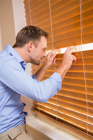 Curious man looking through the blinds at home Stock Photo - Budget Royalty-Free & Subscription, Code: 400-07929730