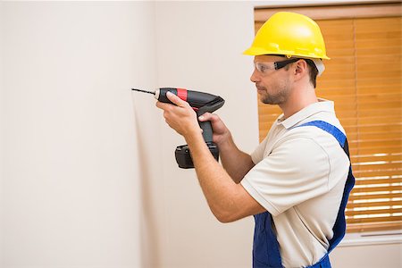 drilling wall - Construction worker drilling hole in wall in a new house Stock Photo - Budget Royalty-Free & Subscription, Code: 400-07929747
