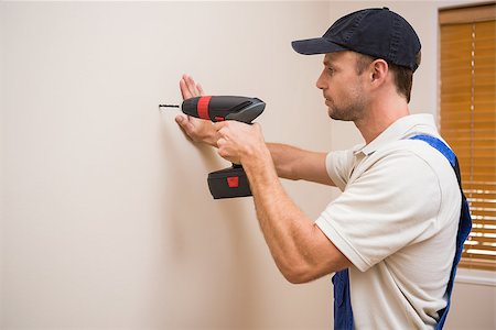 simsearch:400-07929714,k - Construction worker drilling hole in wall in a new house Stock Photo - Budget Royalty-Free & Subscription, Code: 400-07929749