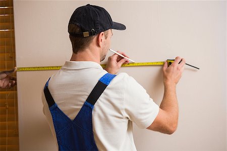 simsearch:400-07929840,k - Construction worker using measuring tape in a new house Foto de stock - Super Valor sin royalties y Suscripción, Código: 400-07929759