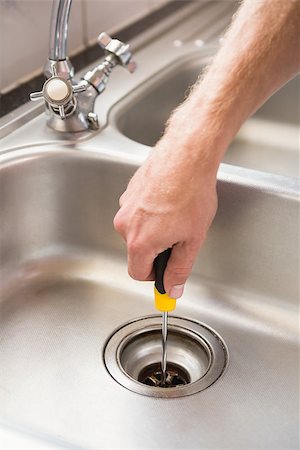 simsearch:400-07929361,k - Man fixing sink with screwdriver at home in the kitchen Stockbilder - Microstock & Abonnement, Bildnummer: 400-07929790