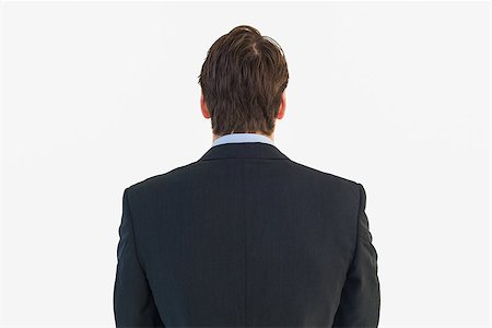 simsearch:400-08076534,k - Rear view of businessman standing on white background Foto de stock - Royalty-Free Super Valor e Assinatura, Número: 400-07929876