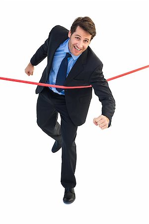 Happy businessman crossing finishing line on white background Stock Photo - Budget Royalty-Free & Subscription, Code: 400-07929925