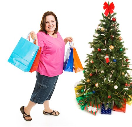Pretty plus sized woman excited about bargain shopping for Christmas.  Full body isolatedo on white. Foto de stock - Super Valor sin royalties y Suscripción, Código: 400-07920872