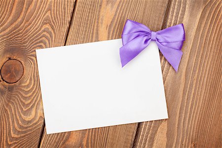 simsearch:400-07922855,k - Greeting card with purple bow over wooden background Fotografie stock - Microstock e Abbonamento, Codice: 400-07921401
