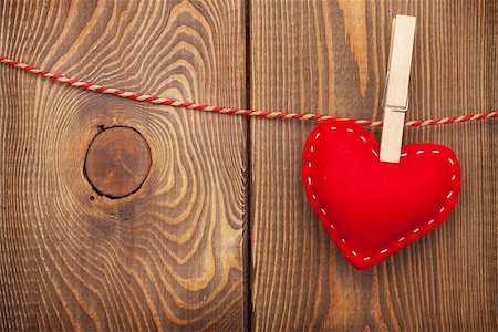 simsearch:400-07922855,k - Red toy valentines heart on rope over wooden background with copy space Fotografie stock - Microstock e Abbonamento, Codice: 400-07921415