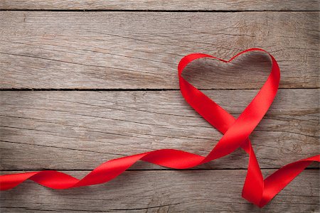 Valentines day heart shaped red ribbon over wooden table background with copy space Stock Photo - Budget Royalty-Free & Subscription, Code: 400-07921419