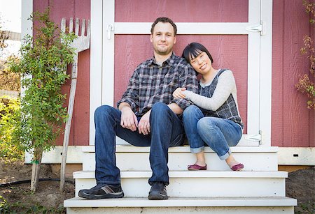 feverpitched (artist) - Happy Mixed Race Couple Relaxing on the Steps of Their Barn. Foto de stock - Royalty-Free Super Valor e Assinatura, Número: 400-07921548