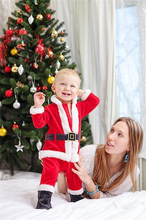 pictures of babies dressed for christmas - Young mother playing with baby dressed in Santa costume Stock Photo - Budget Royalty-Free & Subscription, Code: 400-07921812