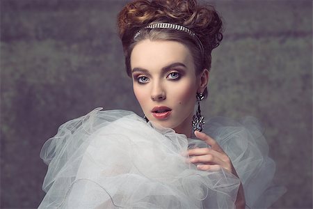 elegant bride hairstyle - charming female wearing like baroque retro dame posing in creative fashion portrait with elegant hair-style, precious tiara and earrings, vintage romantic dress with frill veil collar and stylish make-up. Foto de stock - Super Valor sin royalties y Suscripción, Código: 400-07922622