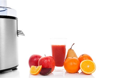 simsearch:400-08977333,k - Multivitamin juice. Juicing background with copy space. Fresh apples, oranges, glass with juice and silver juicer isolated on white background. Healthy fruit eating and drinking. Stock Photo - Budget Royalty-Free & Subscription, Code: 400-07922738