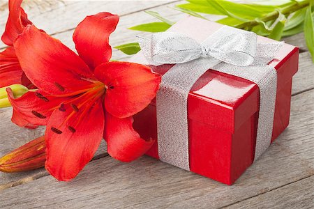 simsearch:400-07662543,k - Red lily flower and gift box on wooden table Stock Photo - Budget Royalty-Free & Subscription, Code: 400-07922767