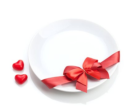 Valentine's Day heart shaped candy and plate with red bow. Isolated on white background Stock Photo - Budget Royalty-Free & Subscription, Code: 400-07922808