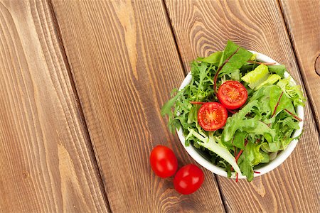 Healthy salad with tomatoes on wooden table. View from above with copy space Stock Photo - Budget Royalty-Free & Subscription, Code: 400-07922849