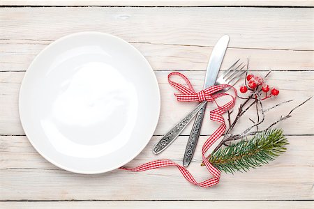 Empty plate, silverware and christmas decor. View from above over white wooden table background Stock Photo - Budget Royalty-Free & Subscription, Code: 400-07922876