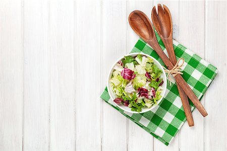 Fresh healthy salad and kitchen utensils over white wooden table. View from above with copy space Stock Photo - Budget Royalty-Free & Subscription, Code: 400-07922886